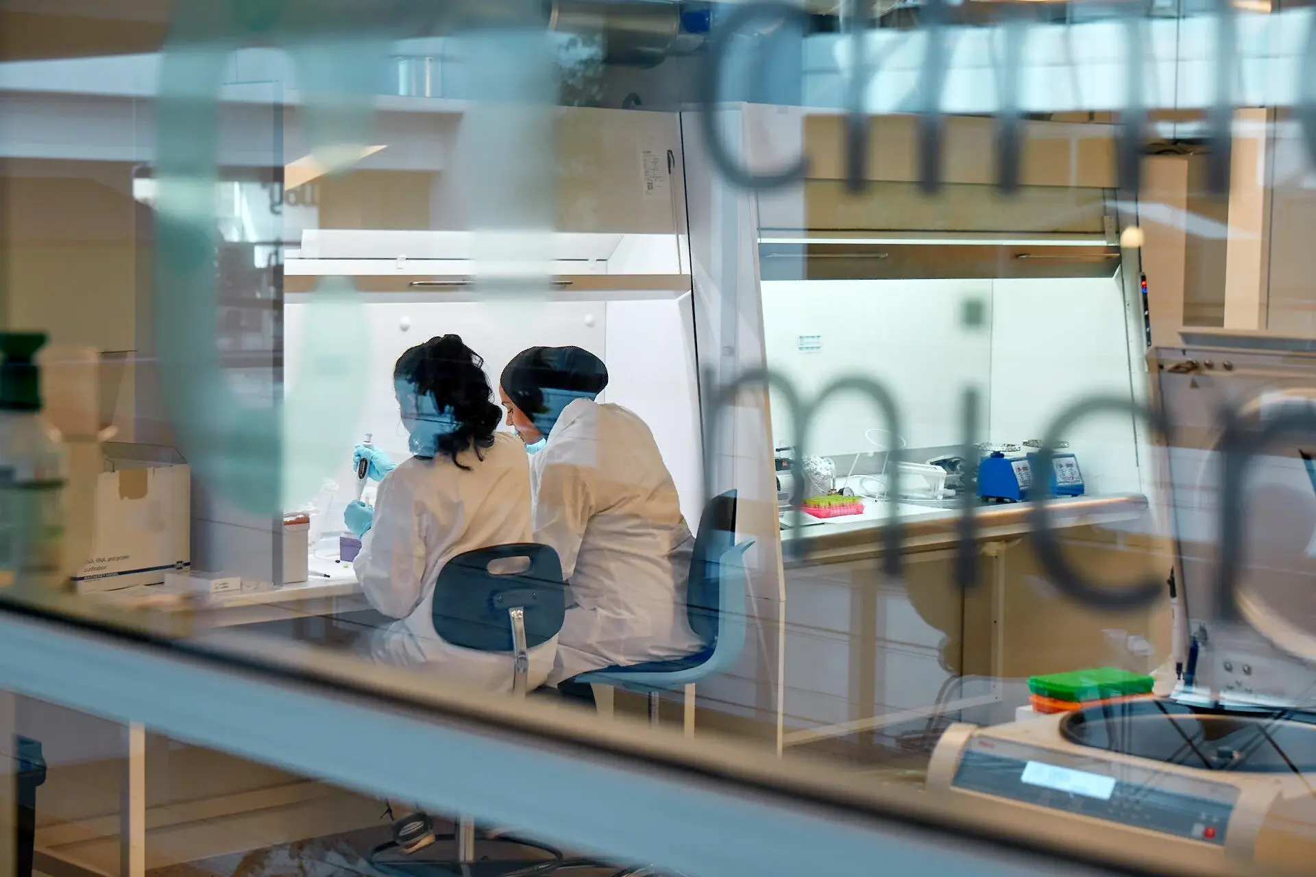 a photo of two cmbio laboratory workers while testing within our microbiological labs