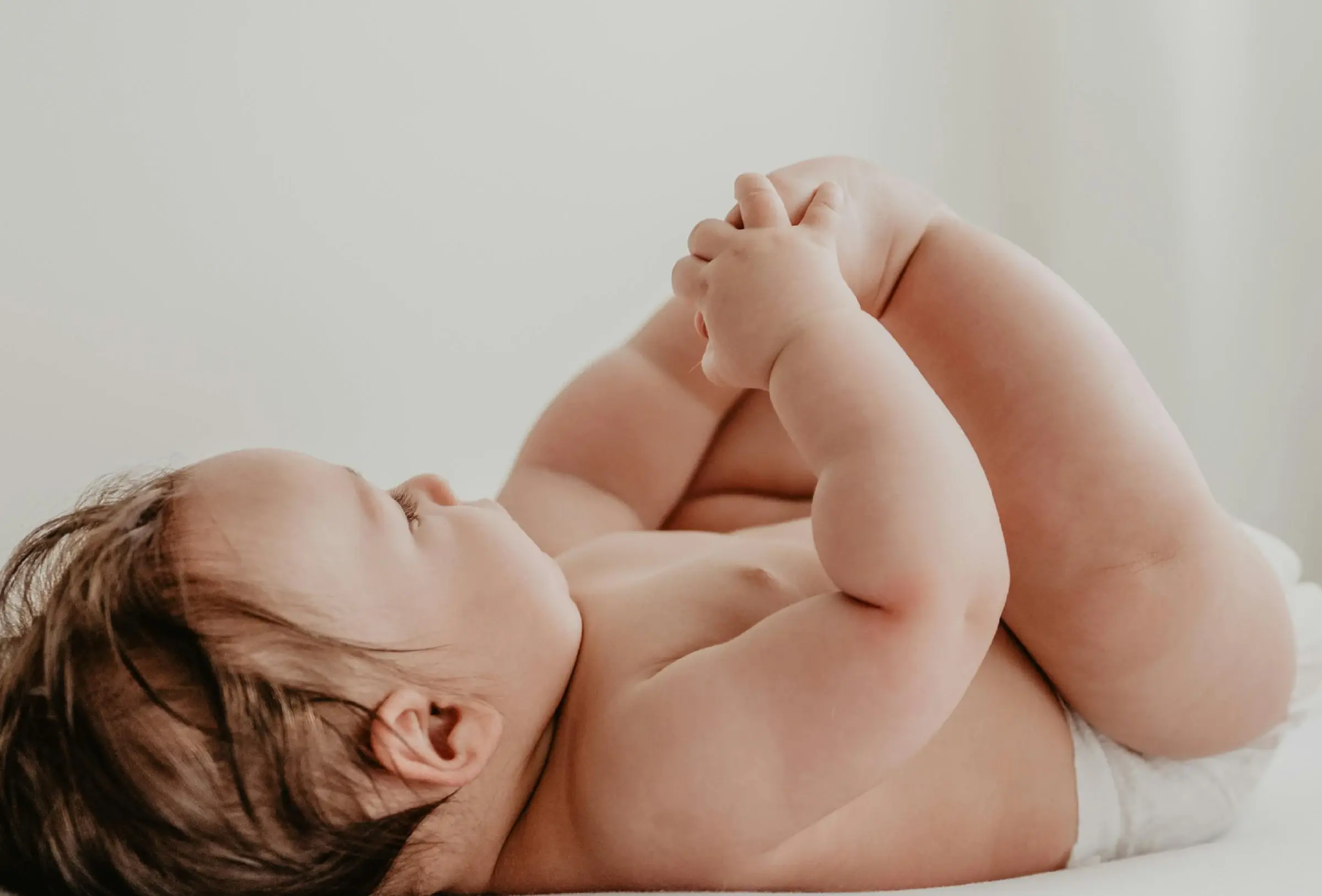 an infant laying on their back